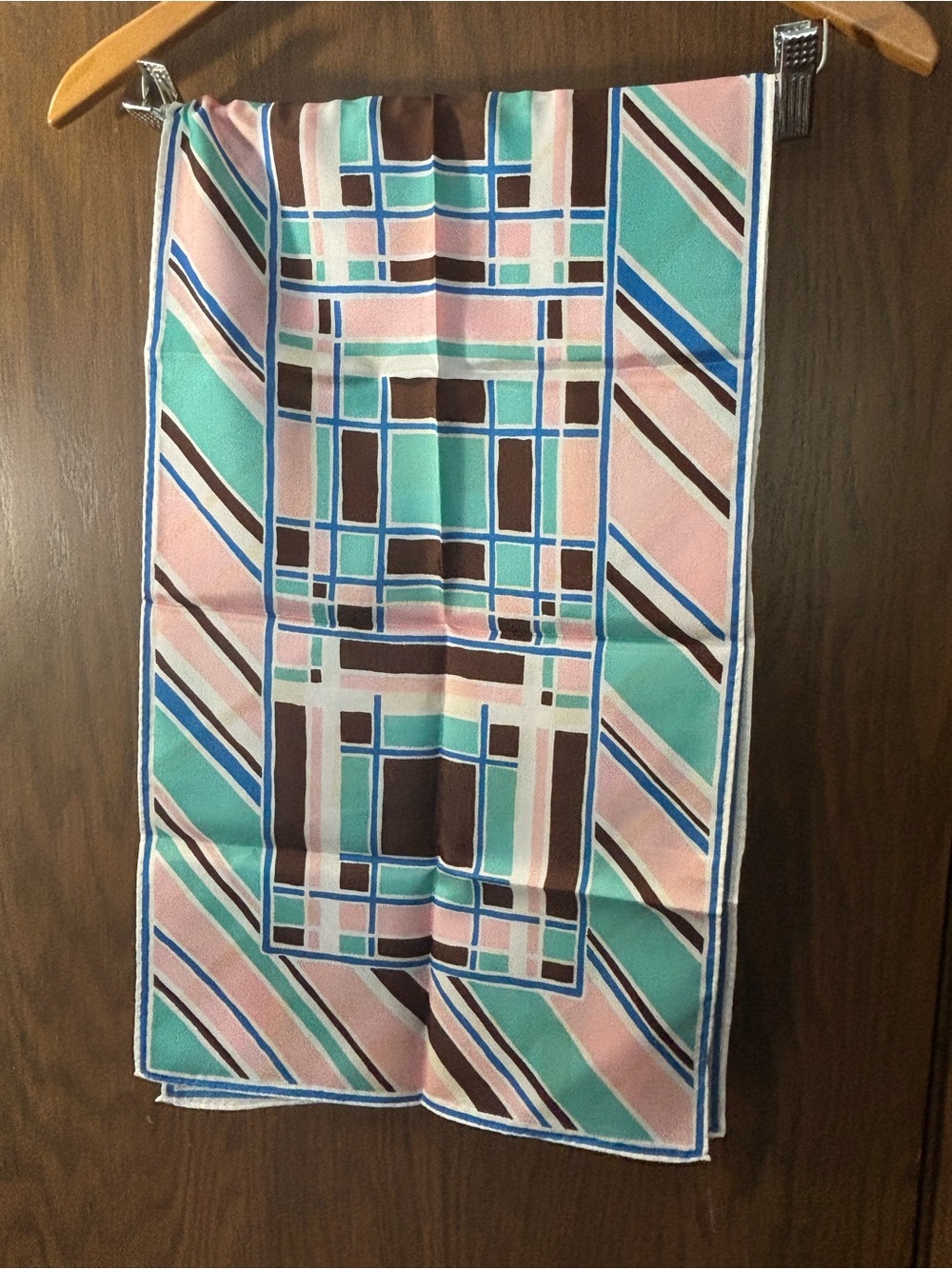 La Dear acetate neck scarf with a colorful, geometric striped pattern.